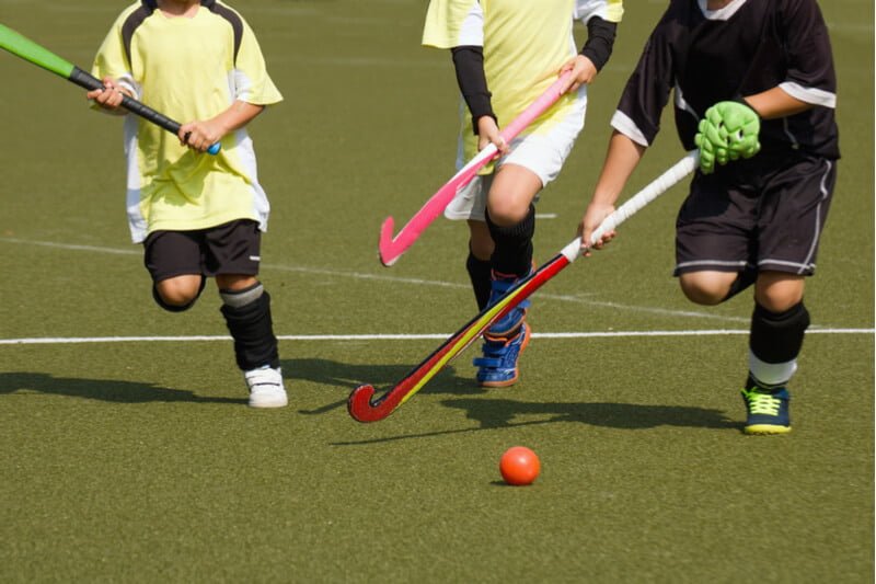 Children playing hockey to develop leadership skills